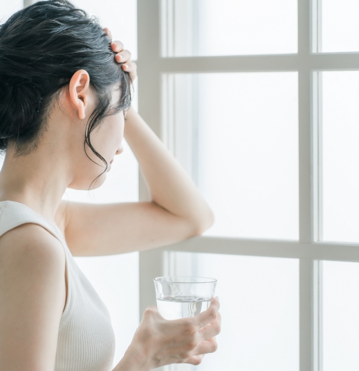 女性が窓の外を見つめる